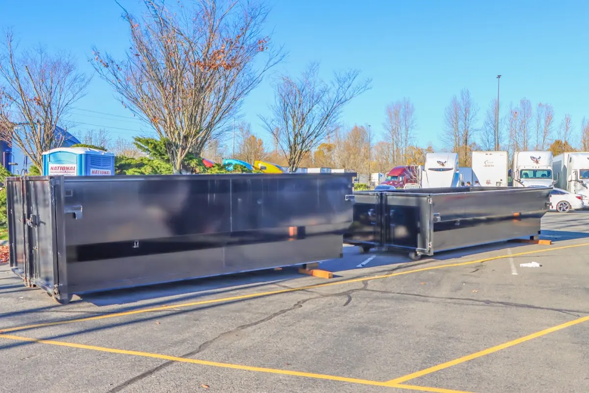 Professional dumpster rental service with roll-off container on residential driveway in Columbia City